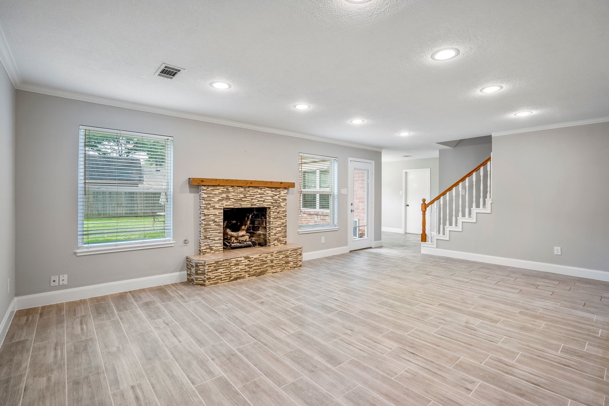 7607 Wycomb Lane Houston, TX 77070 - Photo 10 of 38 a view of an empty room with wooden floor fireplace and a window