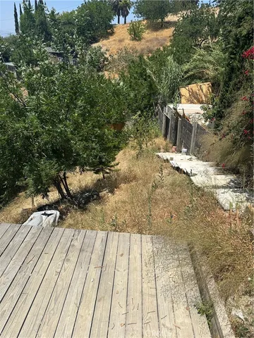 a view of backyard with wooden floor and outdoor seating