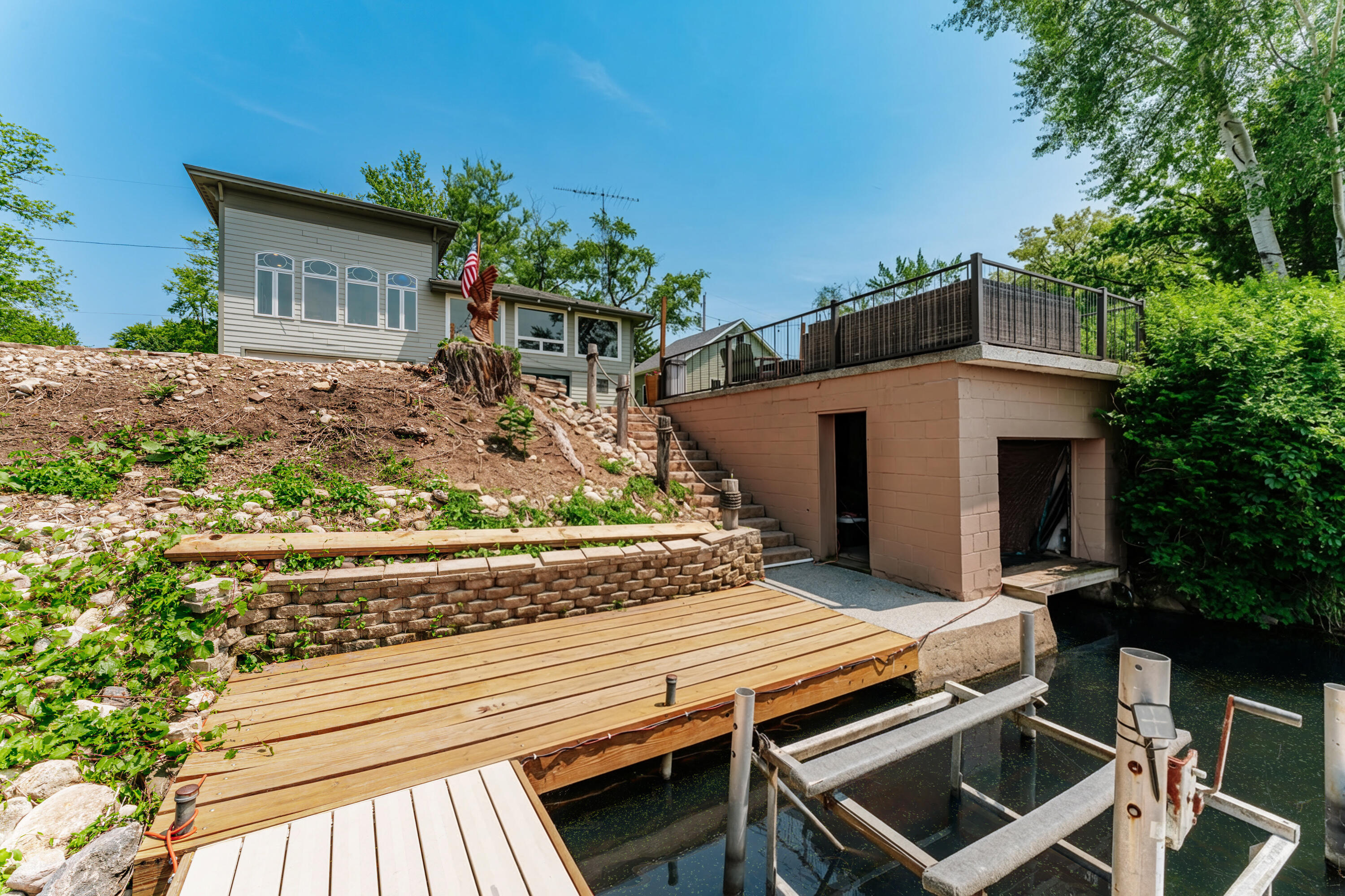 5420 West Peninsula Road Waterford, WI 53185 - Photo 47 of 65 New doors installed on the Boathouse in 2025. Boathouse has a floor which is great for storing kayaks and other equipment.