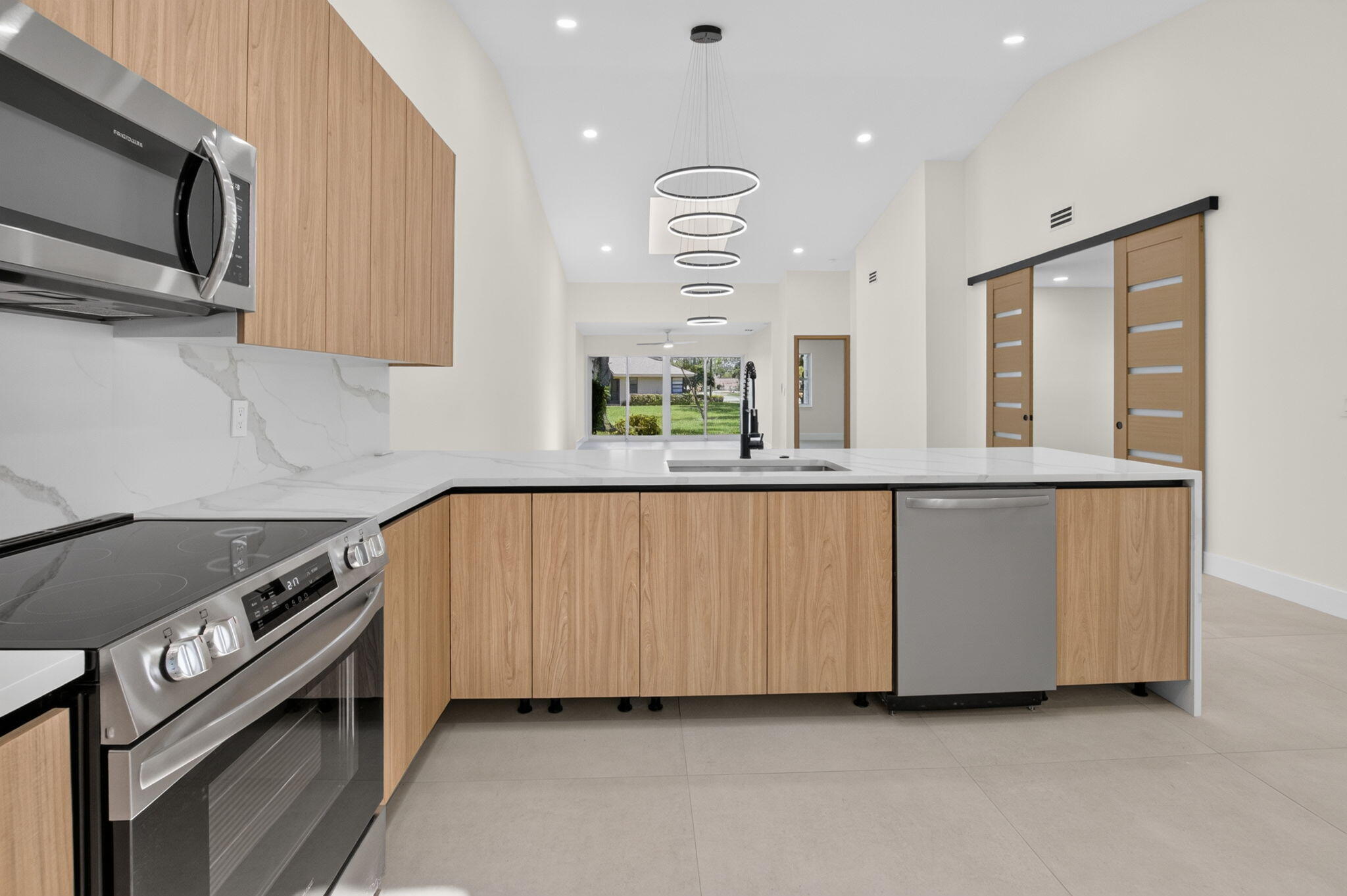 8306 Summersong Terrace Boca Raton, FL 33496 - Photo 12 of 51 a kitchen with stainless steel appliances a stove a sink and a microwave