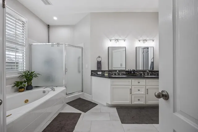 a bathroom with a bathtub and a shower