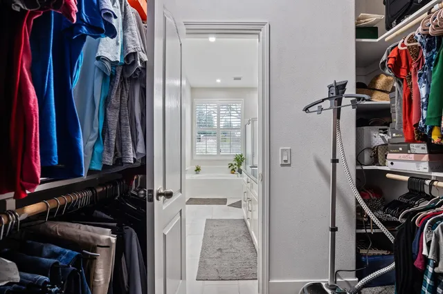 a bedroom with a bed and a chair