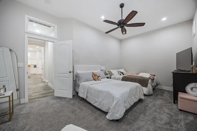 a bedroom with a bed and a chandelier