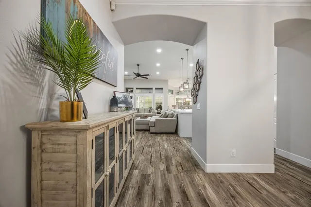 a view of entryway and hall with wooden floor