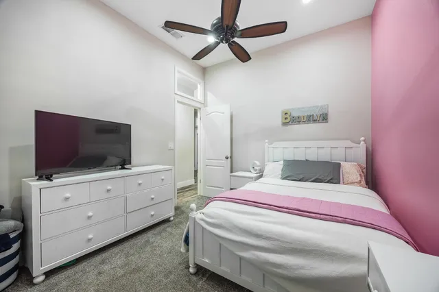 a bed room with a bed and a television