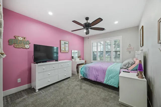 a bedroom with a bed and a flat tv screen