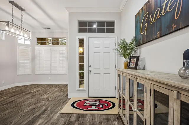 a view of a livingroom with furniture and hardwood floor