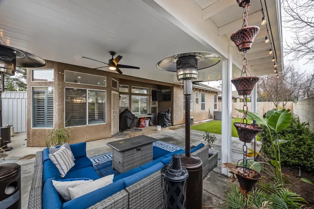 a view of a house with backyard and sitting area