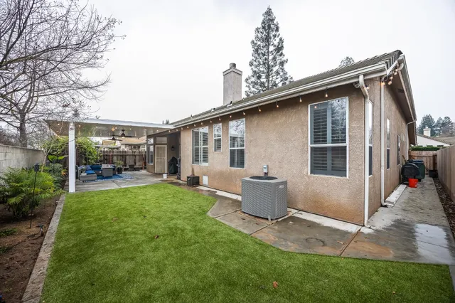 a view of a patio with table and chairs and potted plants