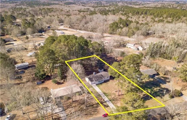 a view of a yard with wooden fence
