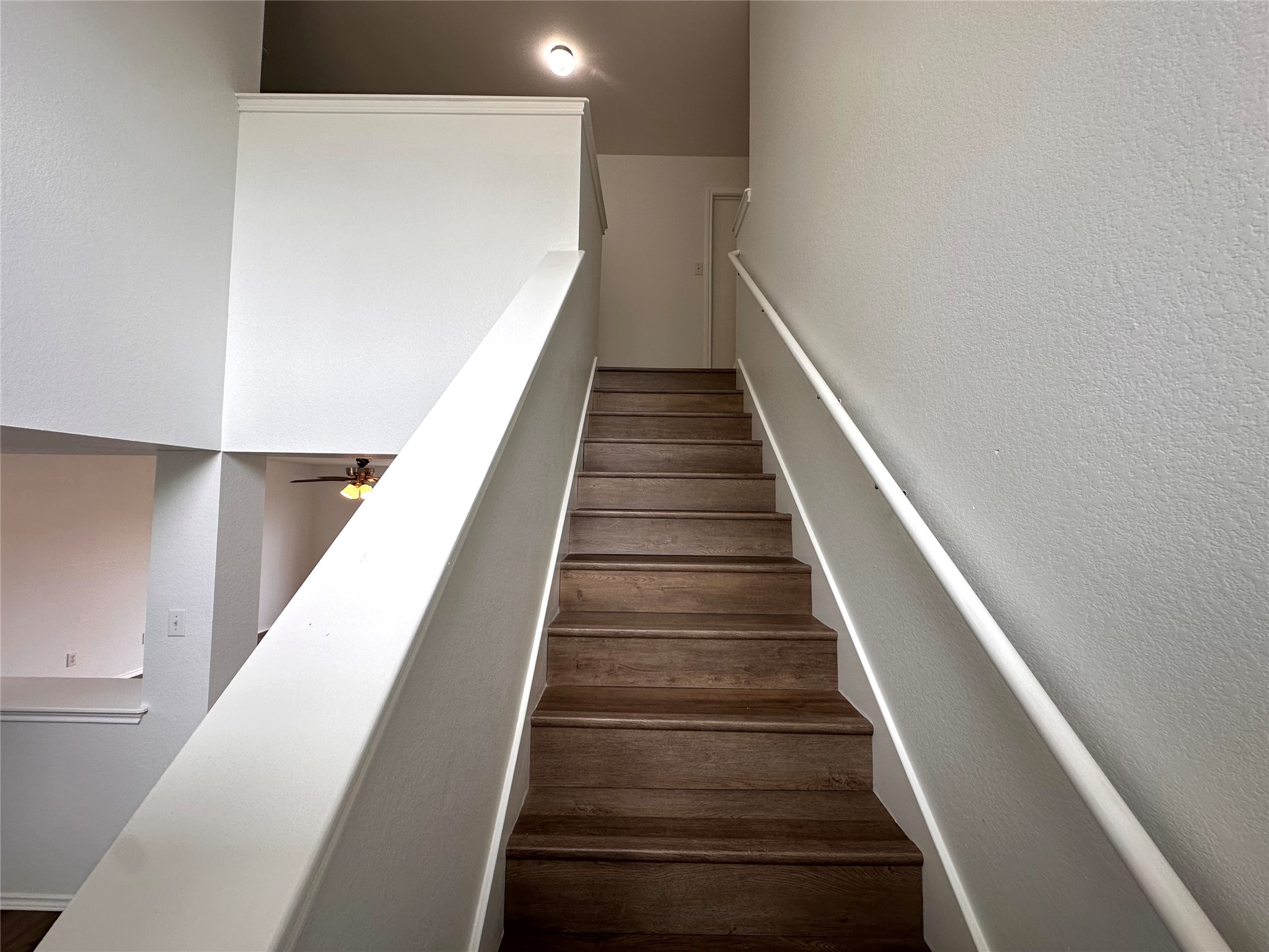 722 Lavaca Loop Elgin, TX 78621 - Photo 8 of 24 Stairs featuring a textured wall and ceiling fan
