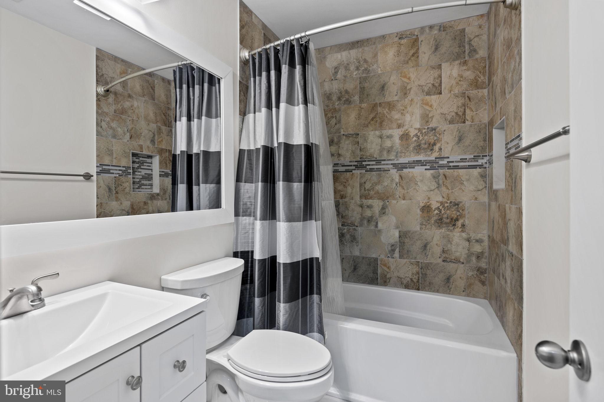 11740 Decade Court Reston, VA 20191 - Photo 30 of 44 Tub shower w/ custom tiling & newer vanity