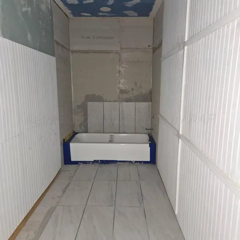 a bathroom with a tub and shower