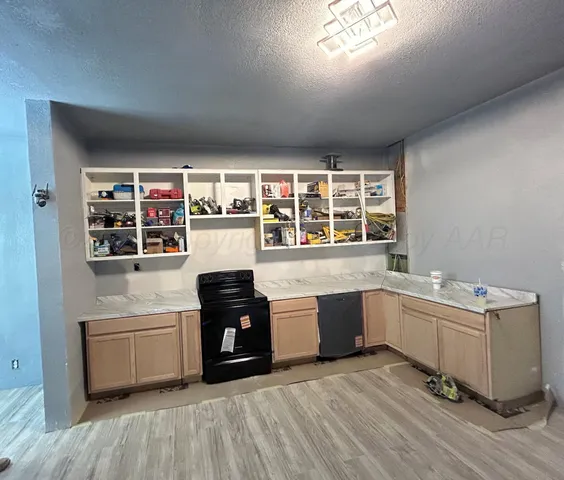 a kitchen with stainless steel appliances a stove and more cabinets