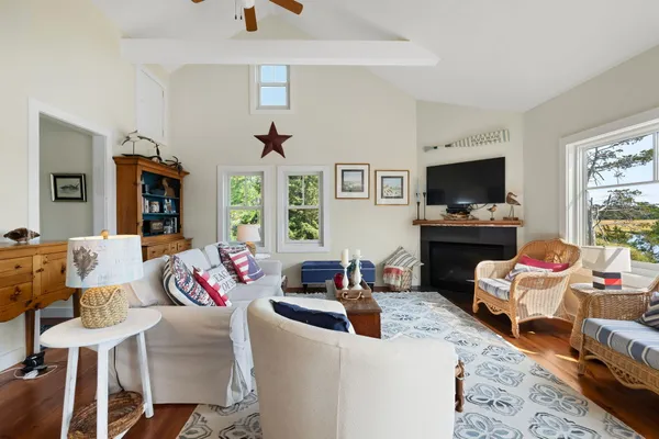 a living room with furniture fireplace and a window