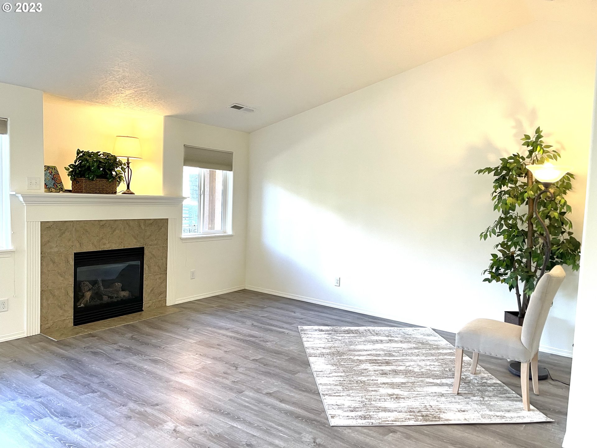 4872 Holly Street Springfield, OR 97478 - Photo 6 of 24 a view of an empty room with wooden floor and a fireplace