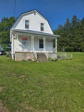 a front view of a house with a yard and porch