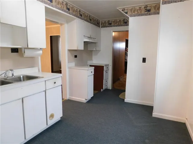 a kitchen with cabinets and white appliances
