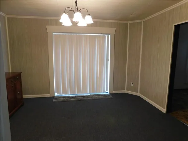 a view of a livingroom with a ceiling fan and window