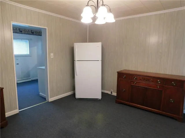 a kitchen with a refrigerator and cabinets