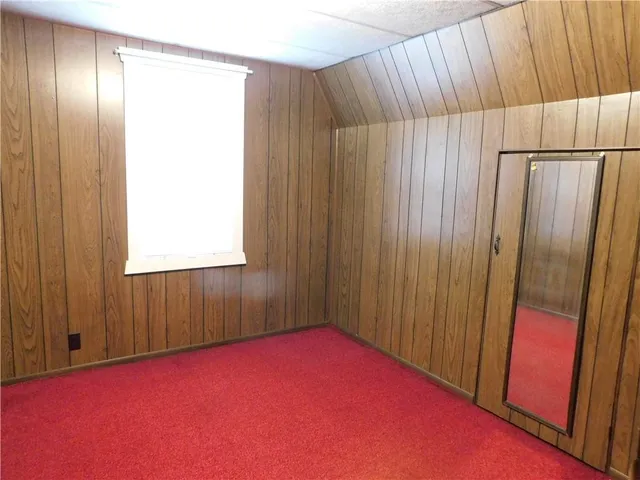 an empty room with a fan and a window