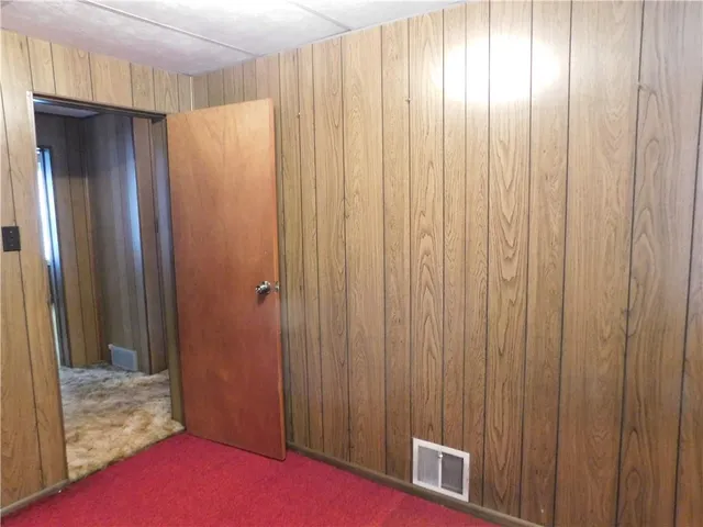 a view of a room with a large window and bathroom
