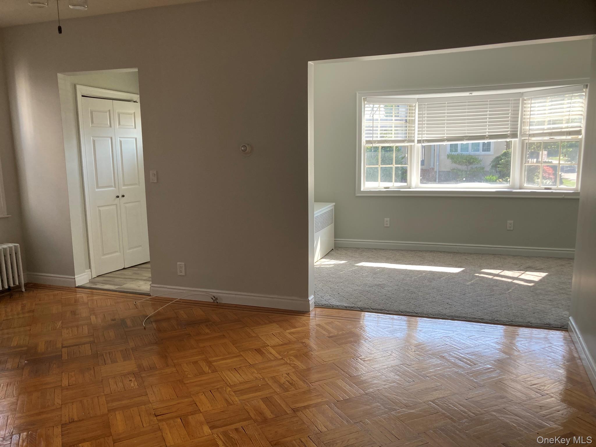 513 Marcellus Road, Unit 1 Williston Park, NY 11596 - Photo 4 of 11 a view of empty room with wooden floor and fan