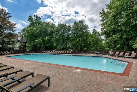 a view of a swimming pool with a yard