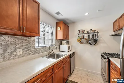 a kitchen with a sink and a stove top oven
