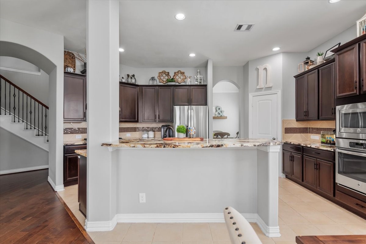 16319 Denise Terrace Drive Hockley, TX 77447 - Photo 19 of 49 a kitchen with kitchen island a sink stove and refrigerator