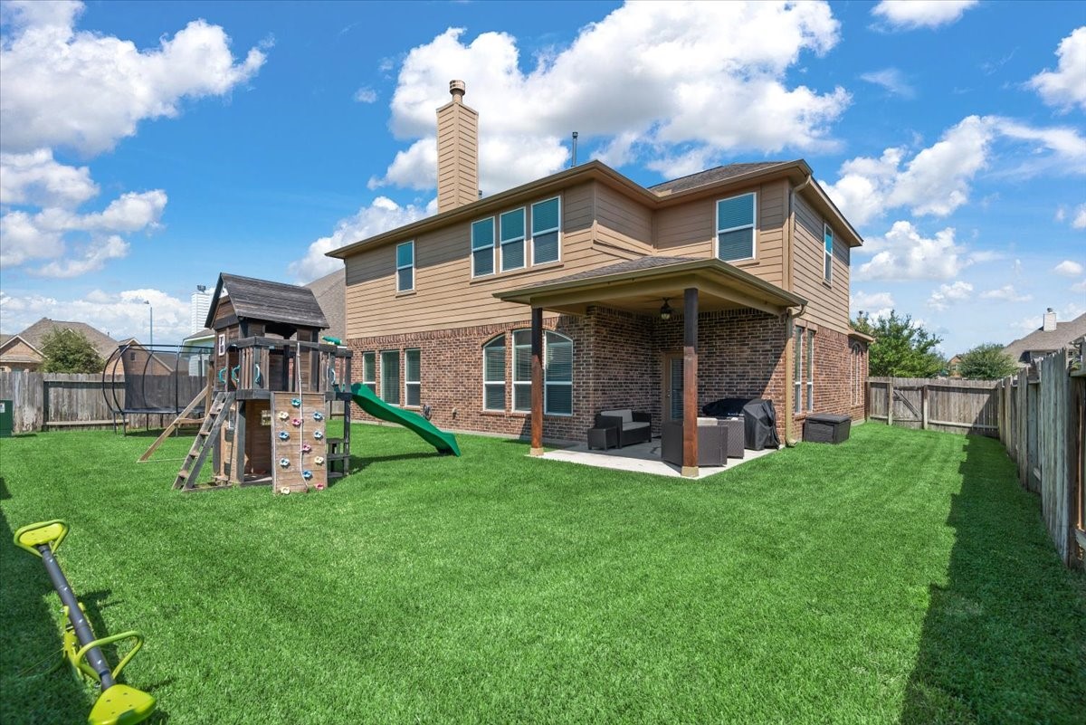 16319 Denise Terrace Drive Hockley, TX 77447 - Photo 2 of 49 a view of a house with a big yard and large trees