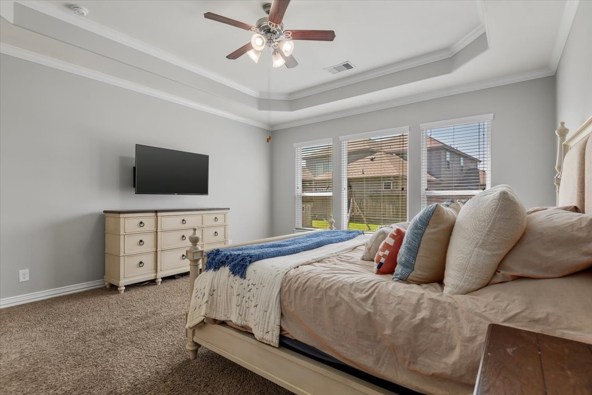16319 Denise Terrace Drive Hockley, TX 77447 - Photo 25 of 49 a bedroom with a large bed and a flat tv screen on dresser