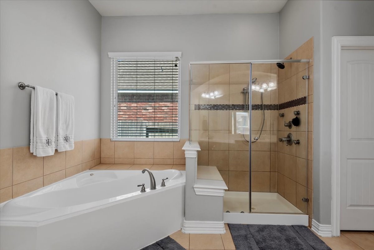 16319 Denise Terrace Drive Hockley, TX 77447 - Photo 27 of 49 a bathroom with a tub a window and a glass door shower