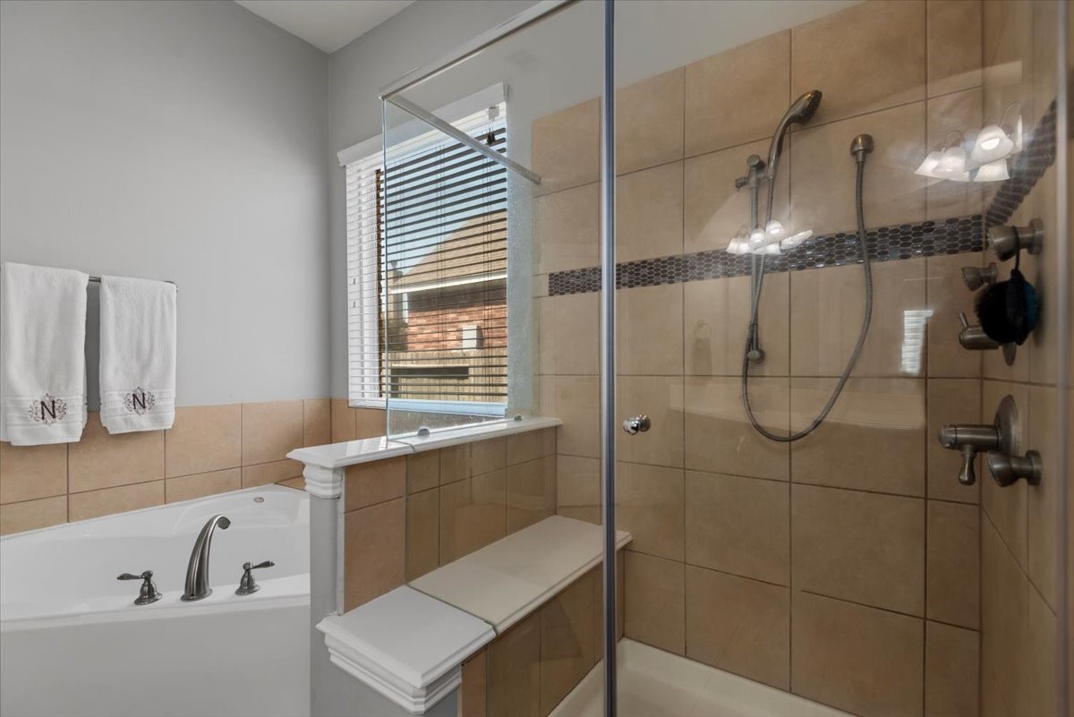 16319 Denise Terrace Drive Hockley, TX 77447 - Photo 29 of 49 a bathroom with a bathtub and a shower