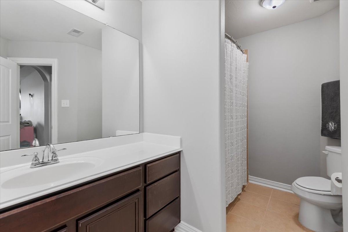 16319 Denise Terrace Drive Hockley, TX 77447 - Photo 34 of 49 a bathroom with a sink a toilet and mirror