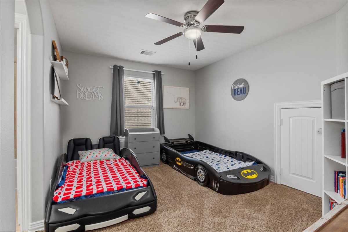 16319 Denise Terrace Drive Hockley, TX 77447 - Photo 36 of 49 a bedroom with a bed and a chandelier