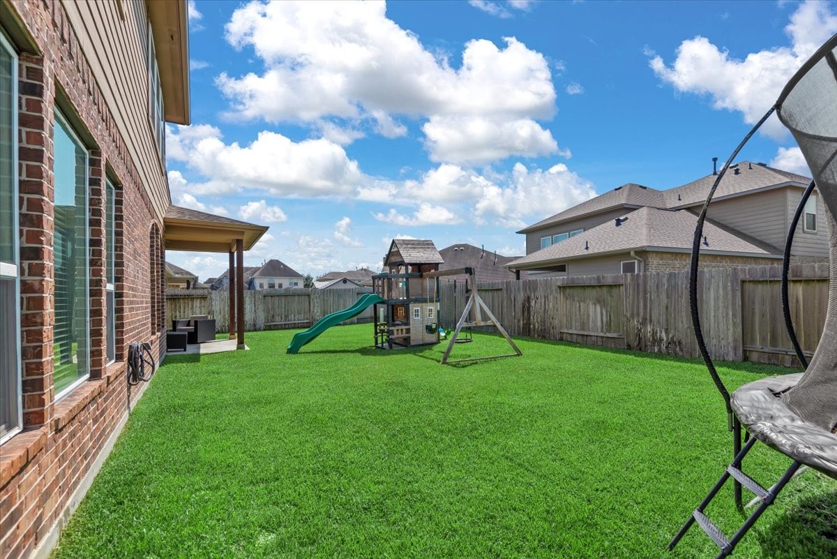 16319 Denise Terrace Drive Hockley, TX 77447 - Photo 46 of 49 a view of a chair and table in backyard of the house