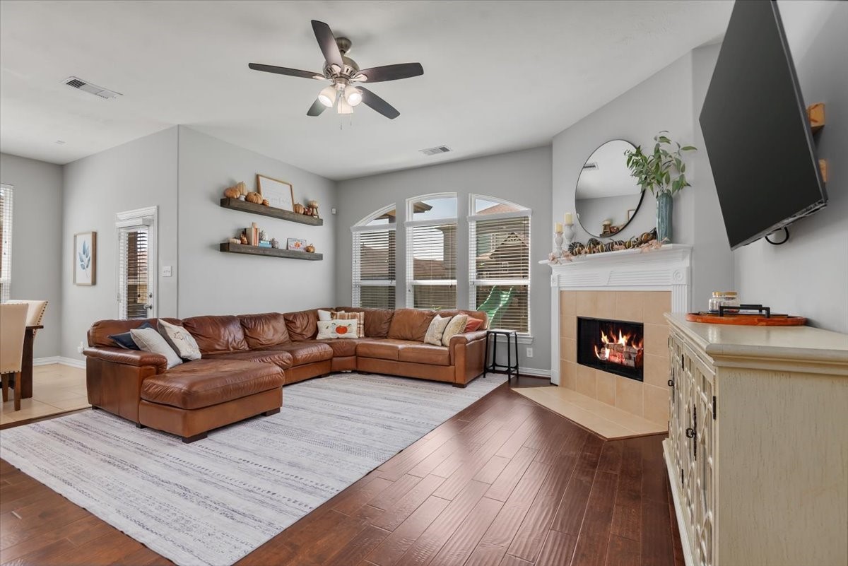 16319 Denise Terrace Drive Hockley, TX 77447 - Photo 5 of 49 a living room with furniture a fireplace and a flat screen tv