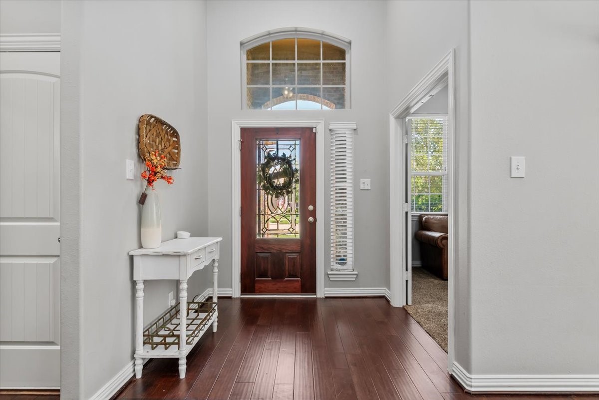 16319 Denise Terrace Drive Hockley, TX 77447 - Photo 10 of 49 a very nice looking room with wooden floor windows and a chandelier