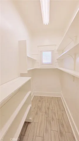 a view of a room with wooden floor and brick walls