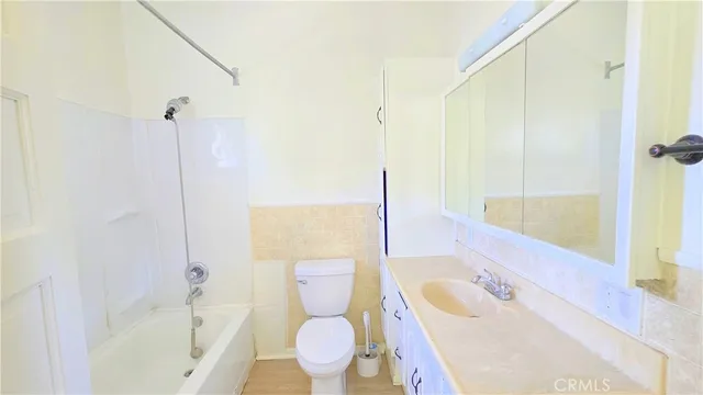 a bathroom with a sink toilet vanity and bathtub