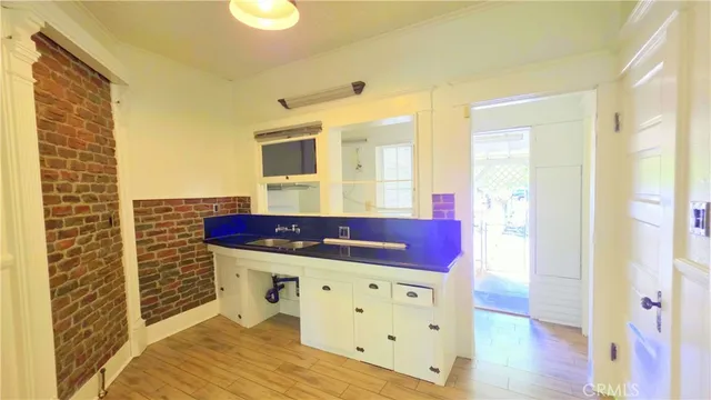 a view of hallway with furniture and wooden floor