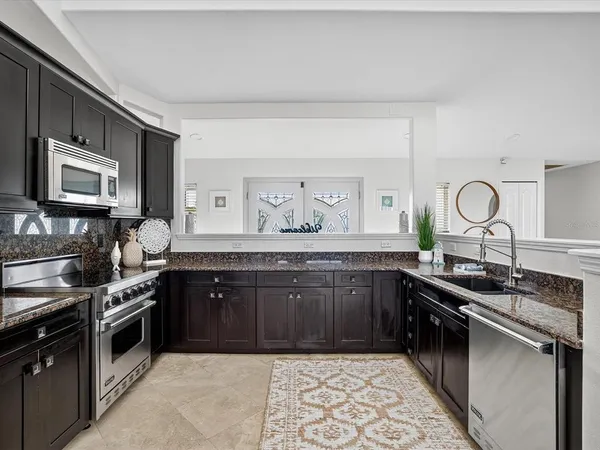 a kitchen with a sink stove and microwave