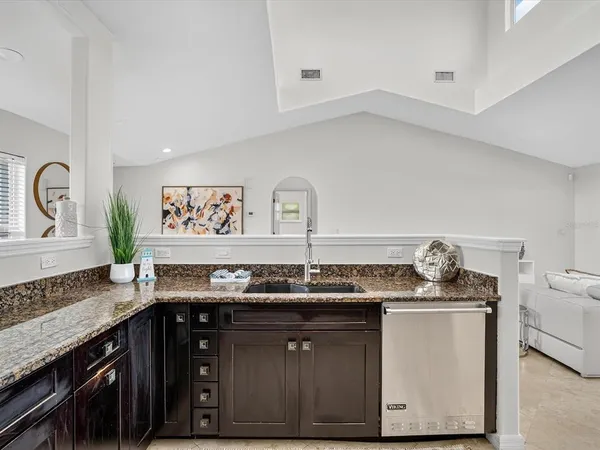 a kitchen with stainless steel appliances granite countertop a sink stove and cabinets