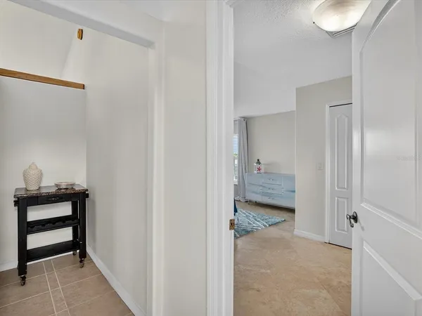 a large bedroom with a bed and large window