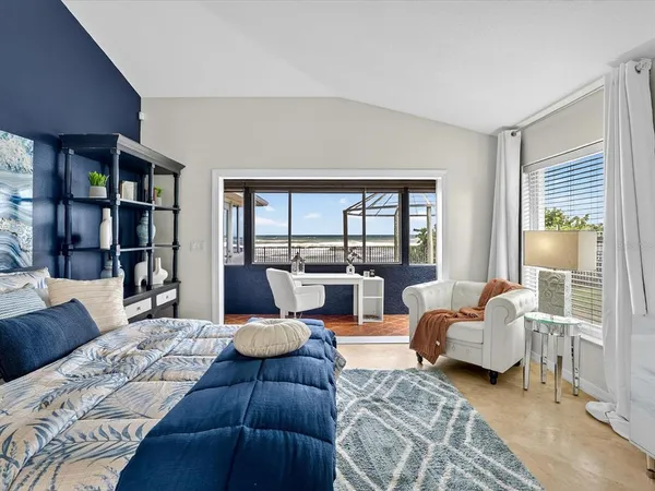 a bedroom with furniture and a large window