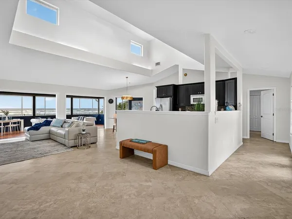 a living room with furniture and white cabinets