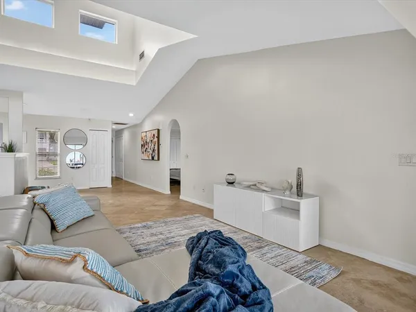 a spacious bedroom with a bed and couch