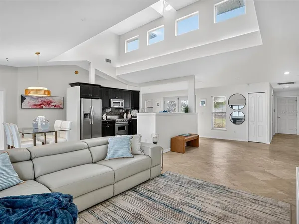 a living room with furniture and kitchen view