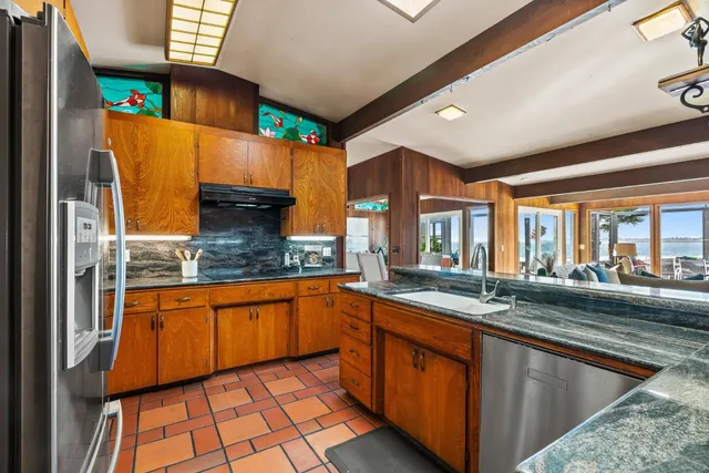 a bed room with a bed and a painting on the wall